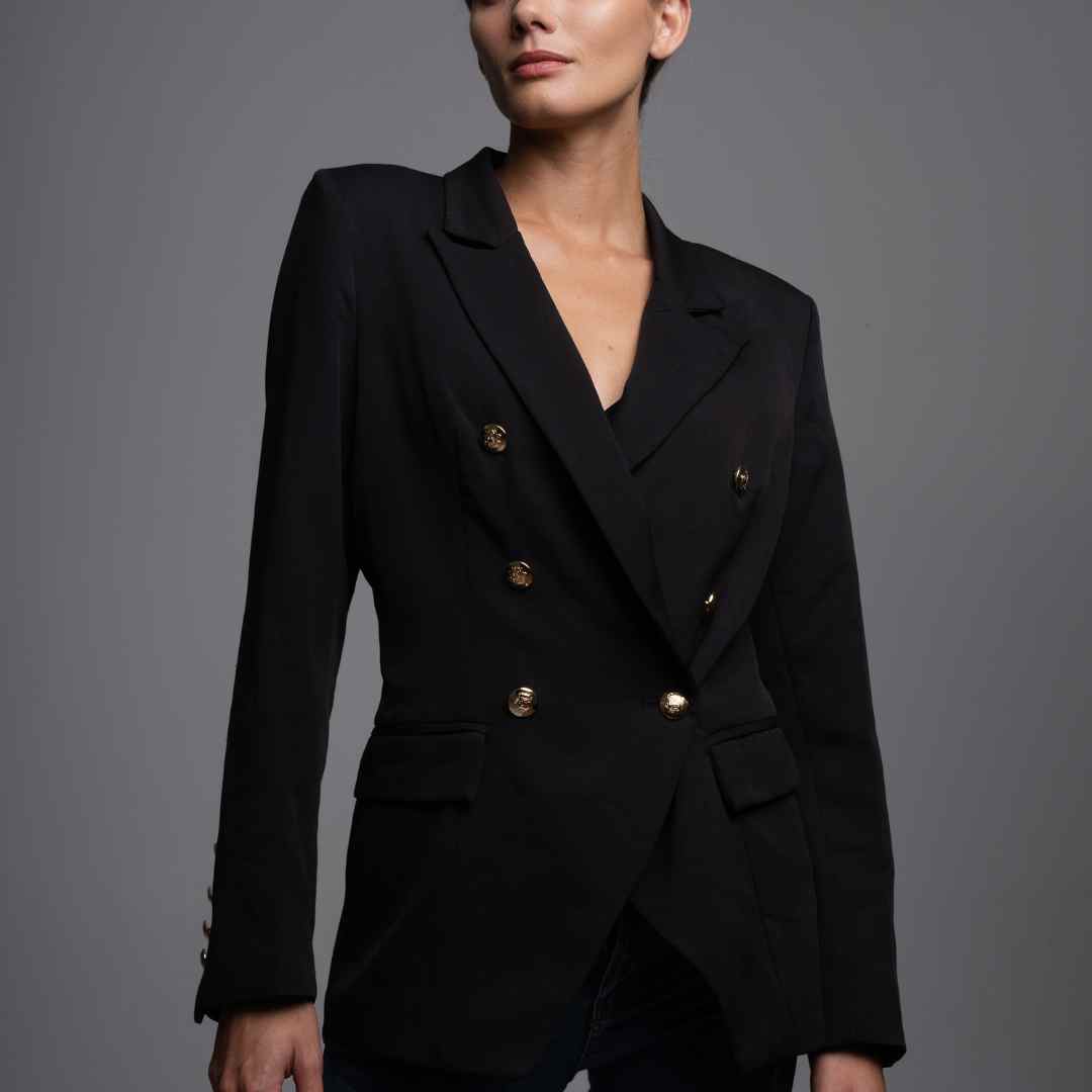 Women in black busines style double breated jacket and pant