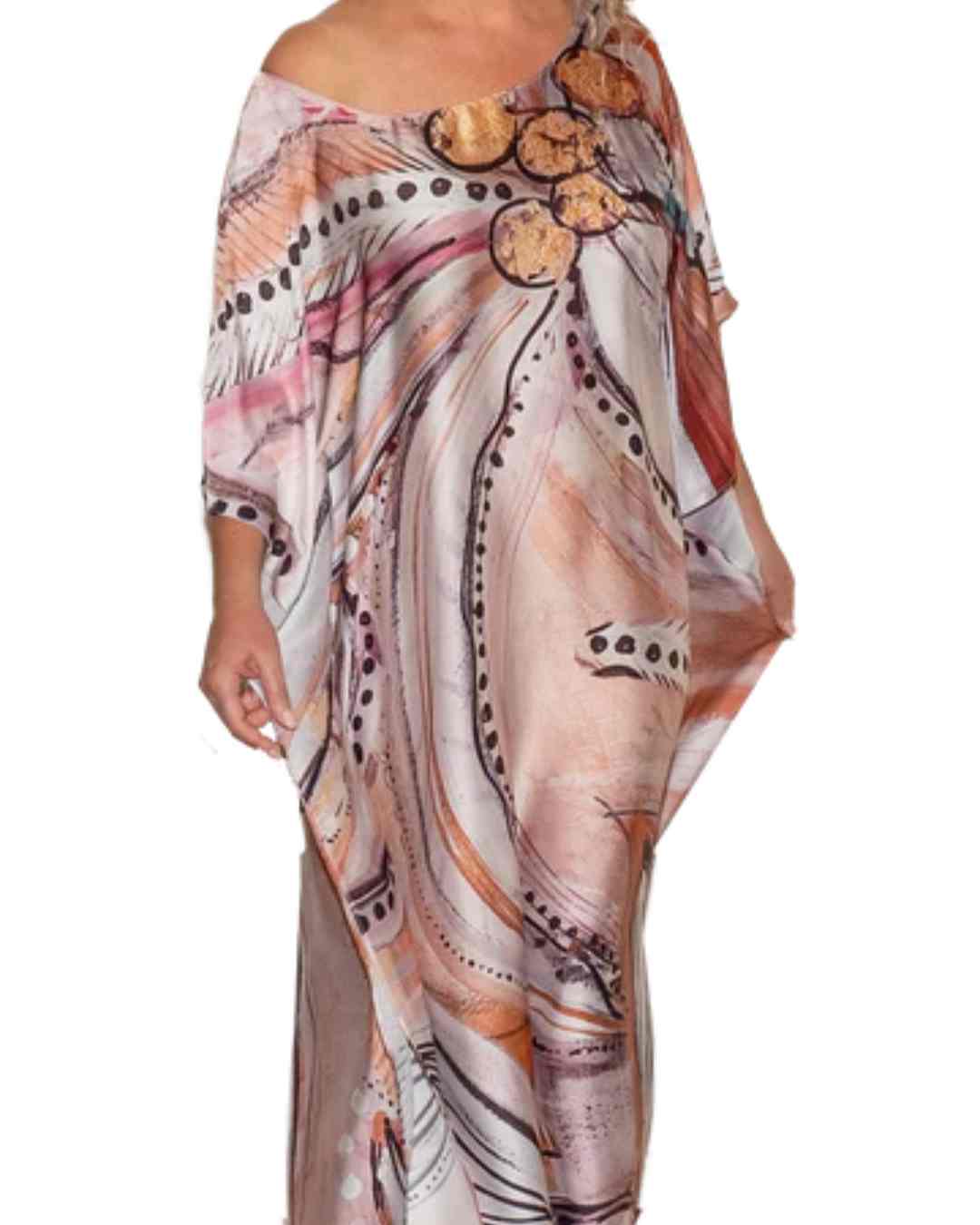 Image of a women wearing a kaftan with an abstract design in pastel tones
